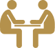 Two people sitting at a table with one of them holding the other 's hand.